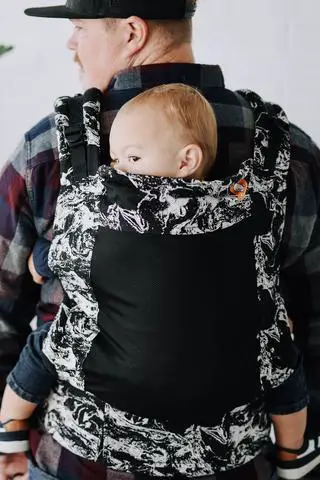 father with a child in a back carrier for toddler
