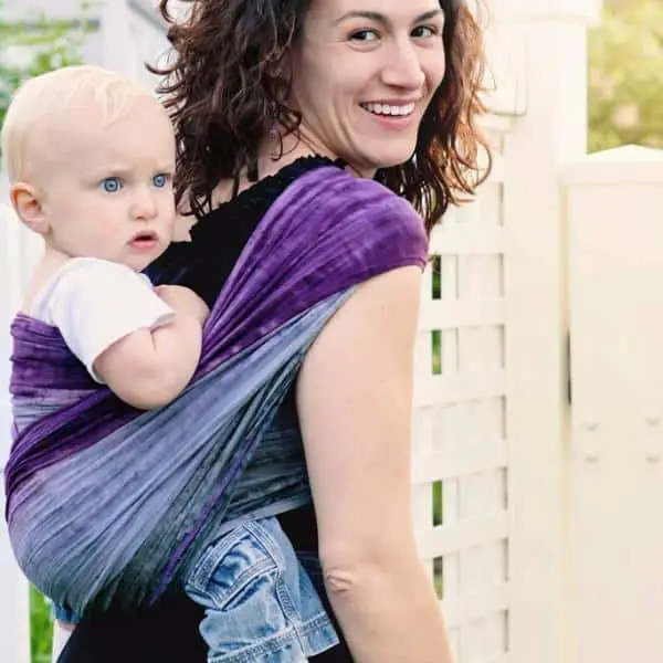 mother carrying her baby in a purple and blue Wrapsody Breeze breathable wrap