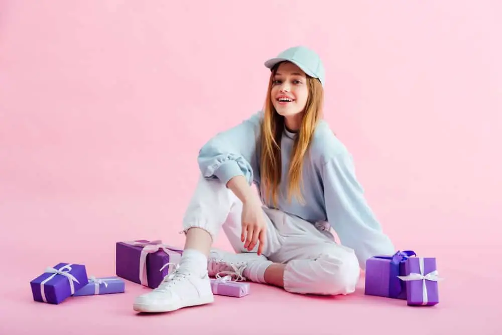 teenage girl surrounded by the best travel gifts for teens