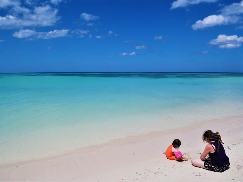 Kath and N playing in the white sand of Playa Jutias, Cuba