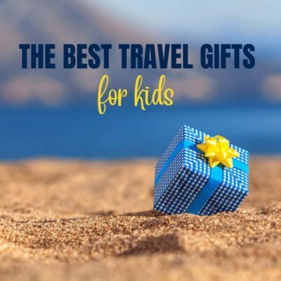 gift on a beach and the text: The best travel gifts for kids in blue and yellow