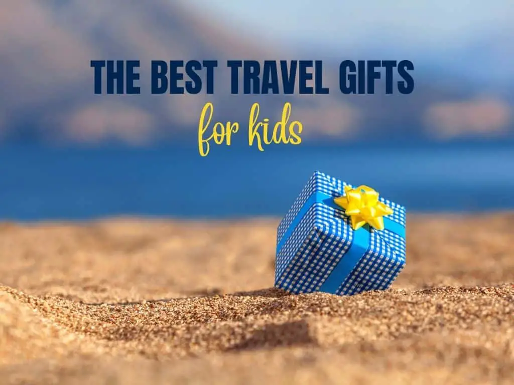 gift on a beach and the text: The best travel gifts for kids in blue and yellow