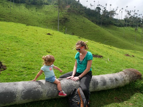 Kath & Little Elf sitting on a fallen palm tree in the Valle de Cocora Salento Colombia