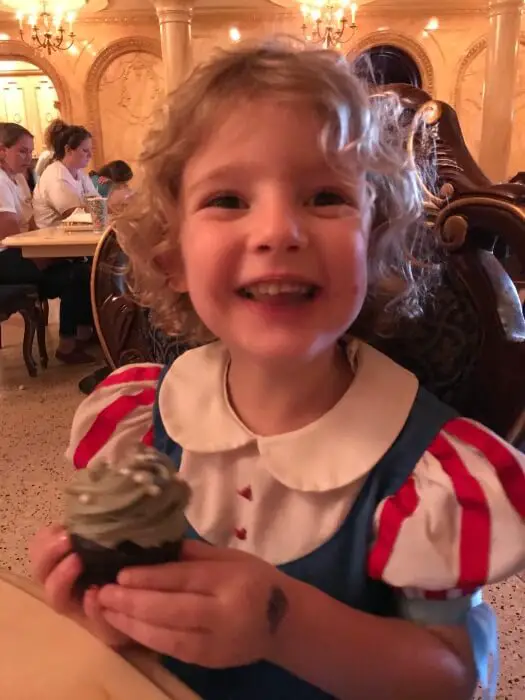 child smiling at the camera in snow white costume