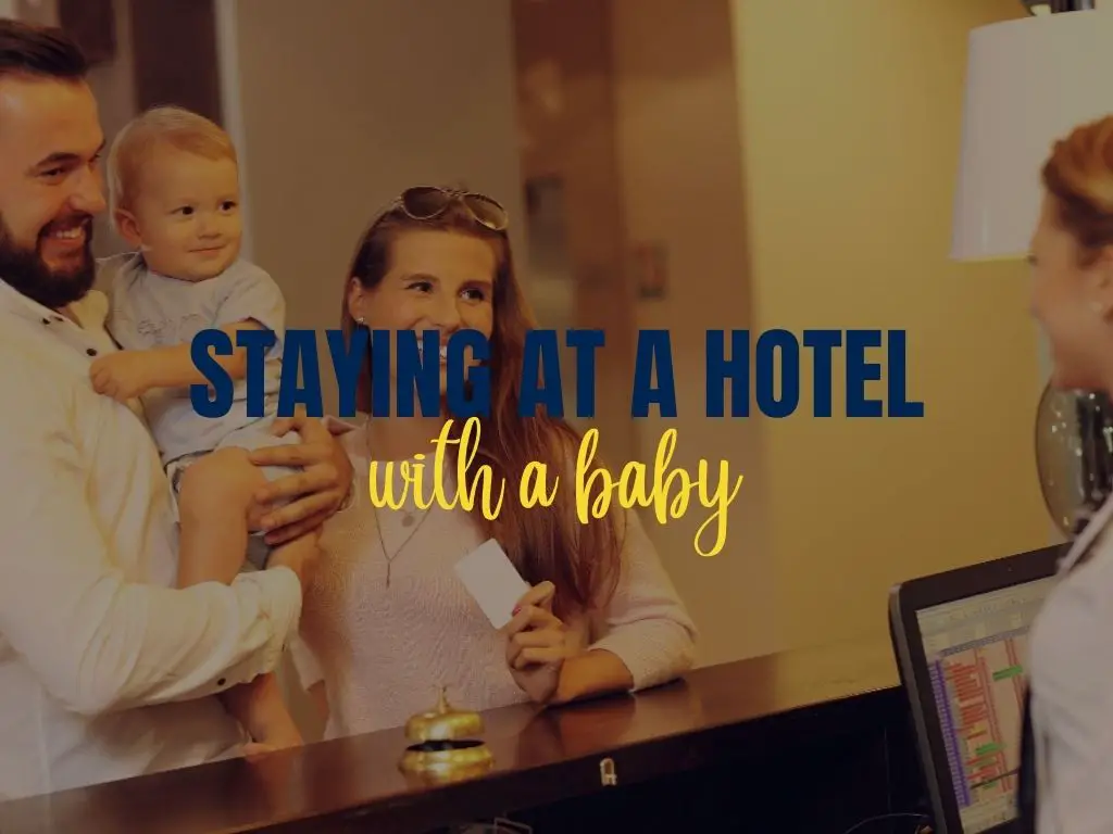 family checking in into a hotel with overlaying text that says 'staying at a hotel with a baby'