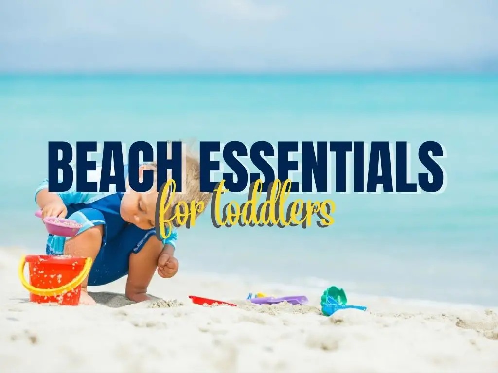 a toddler playing on the sand with beach toys with an overlaying text of beach essentials for toddlers