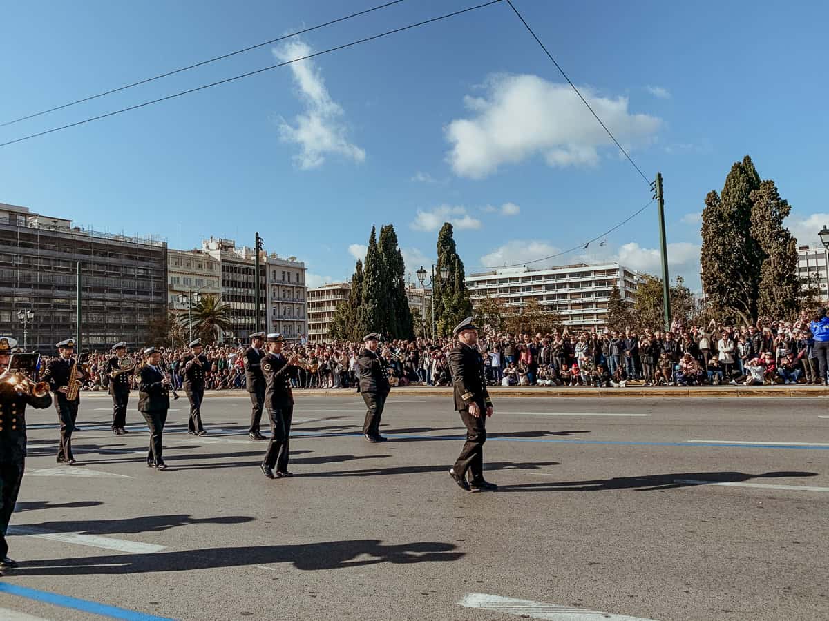 The brass band marching by, wearing a black costume.