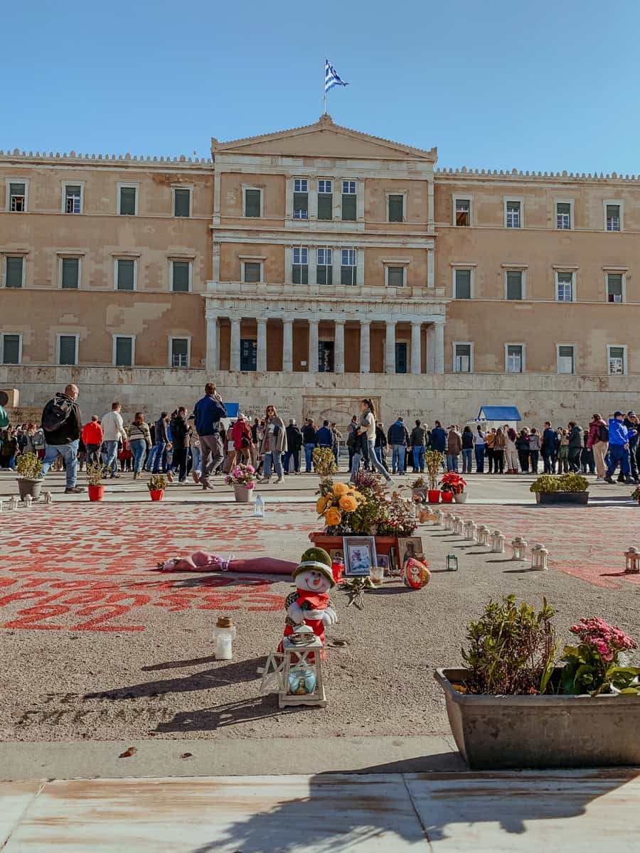 The Parliament with a crowd gathered in front of the monument and the rememberance square.