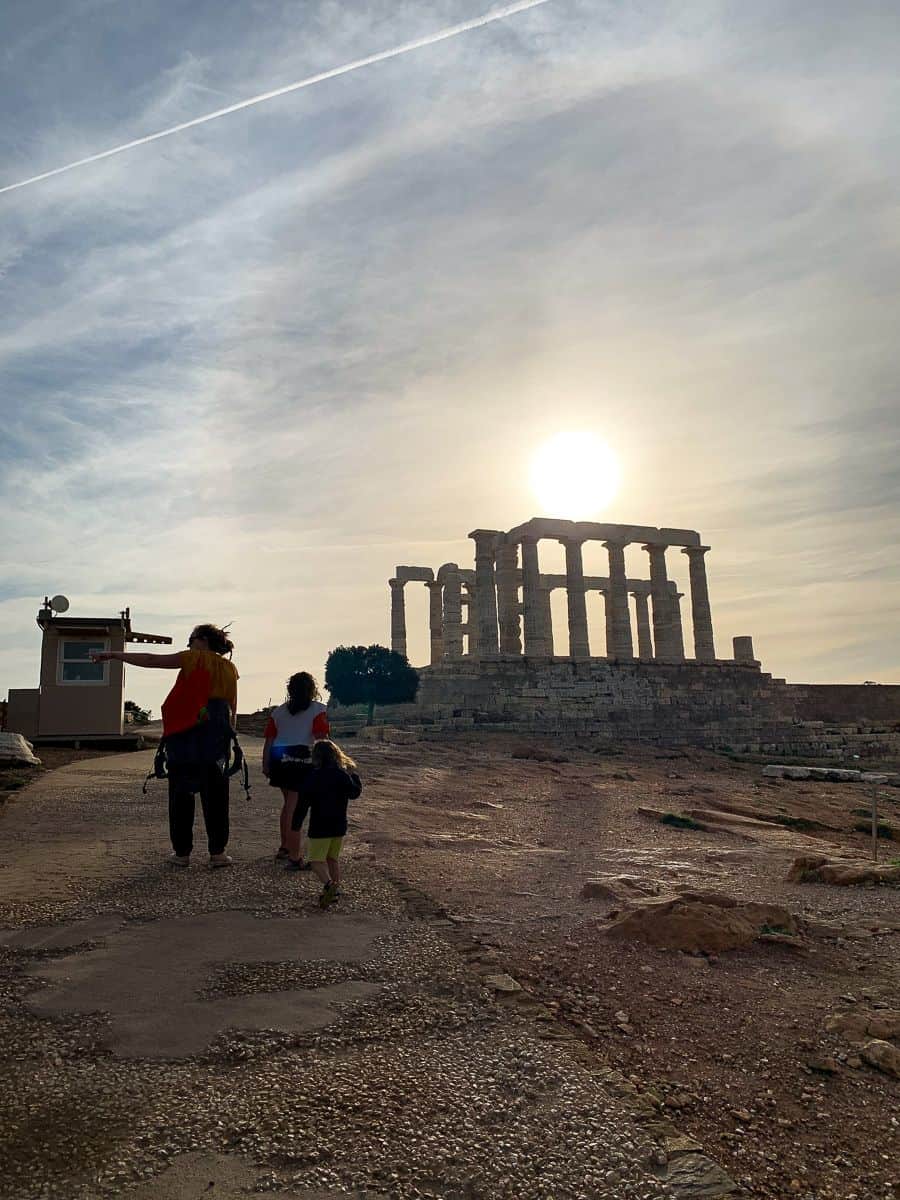 Our family walking towards the columns of the Temple of Poseidon as the sun sets.