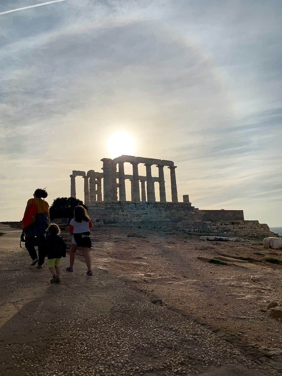 Our family walking towards the columns of the Temple of Poseidon as the sun sets.