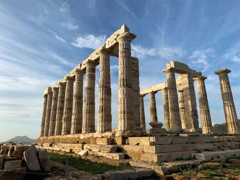 Ruins of the Temple of Poseidon with its tall white marble Doric columns.