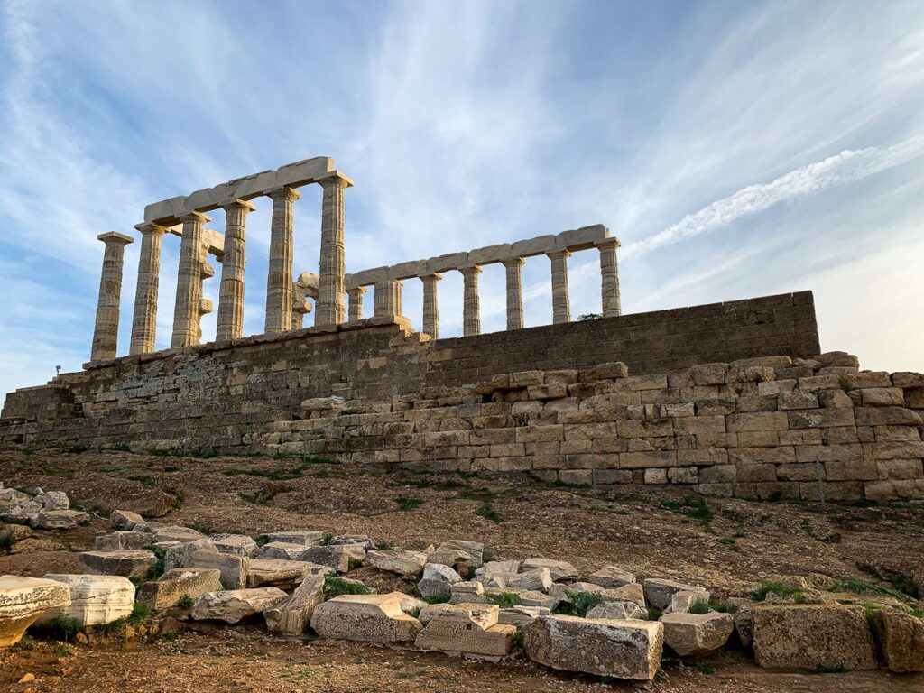 The Temple of Poseidon surrounded by rocks.