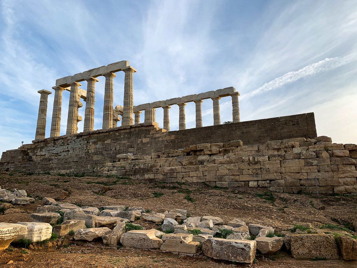 The Temple of Poseidon surrounded by rocks.