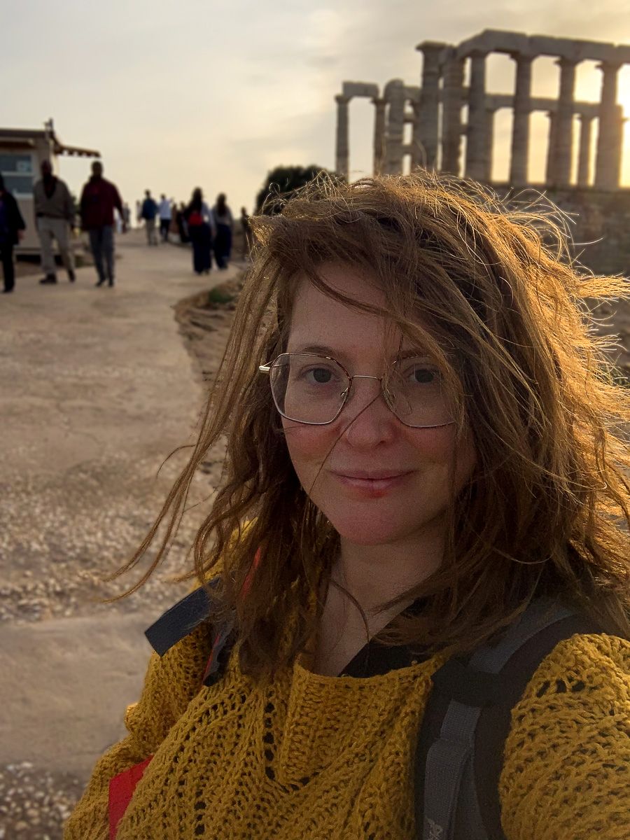 Babs wearing a yellow top near the Temple of Poseidon.