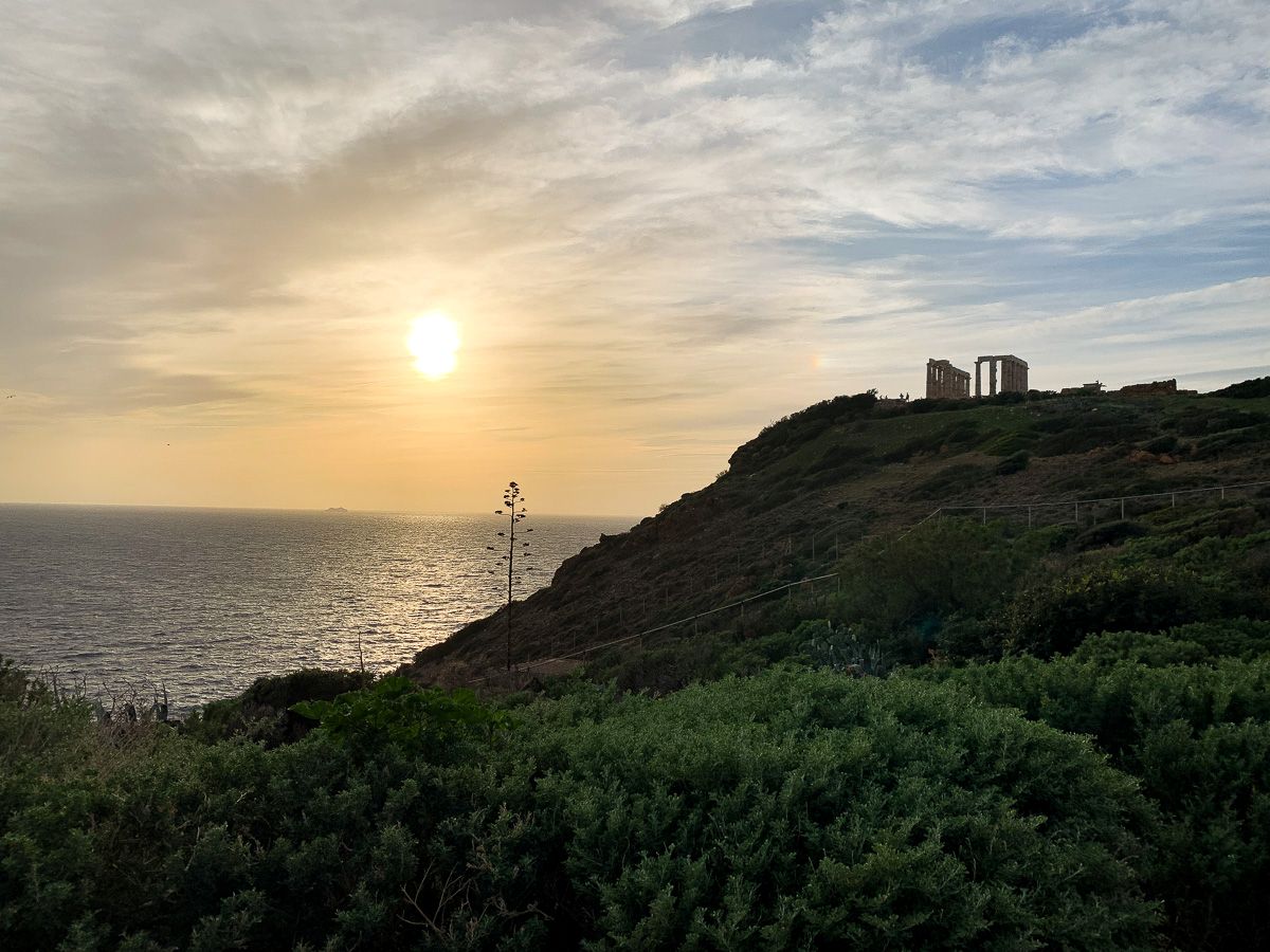 Temple of Poseidon on a sunset, with the island's silhouette.