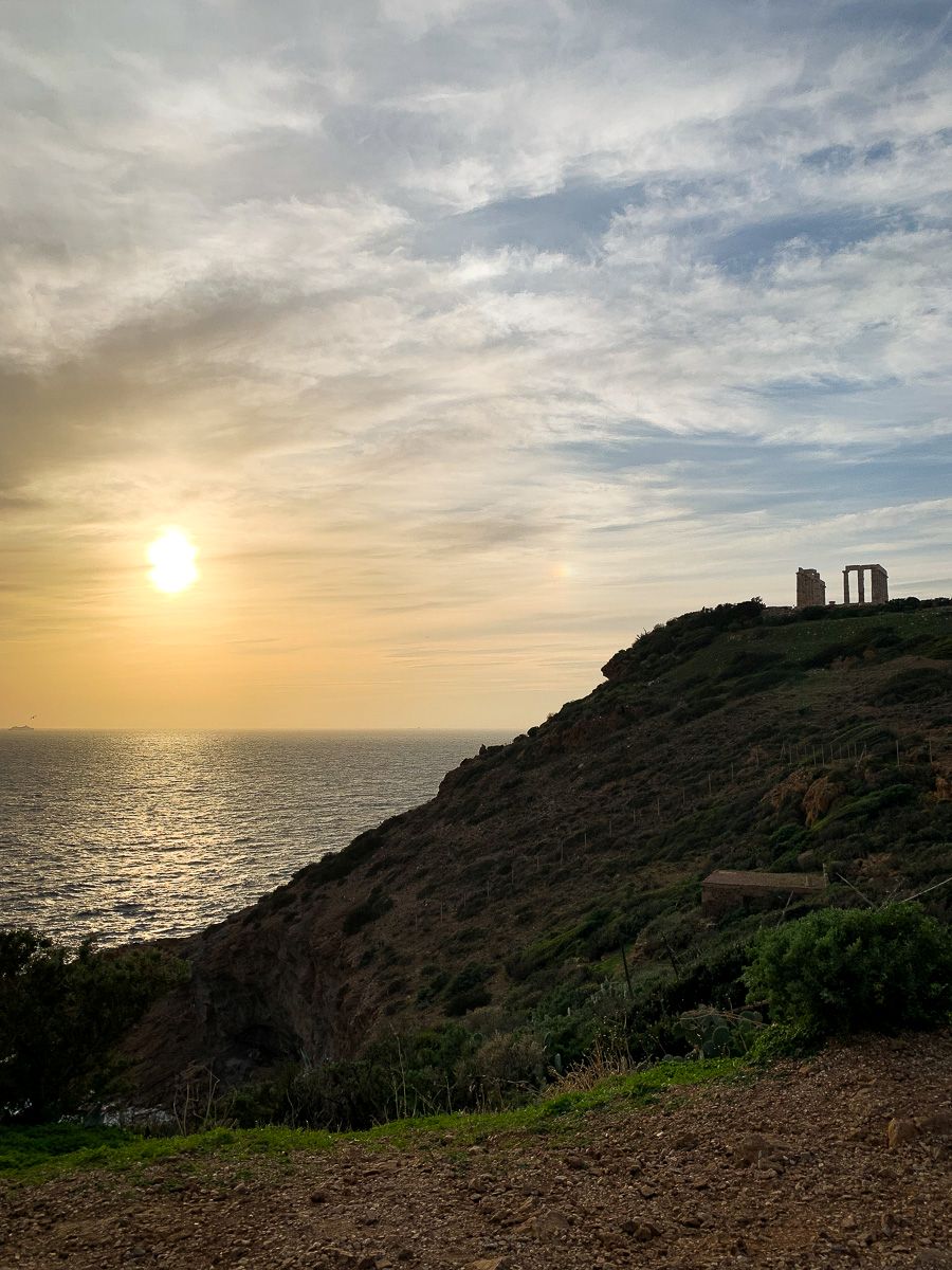 Temple of Poseidon on a sunset, with the island's silhouette.