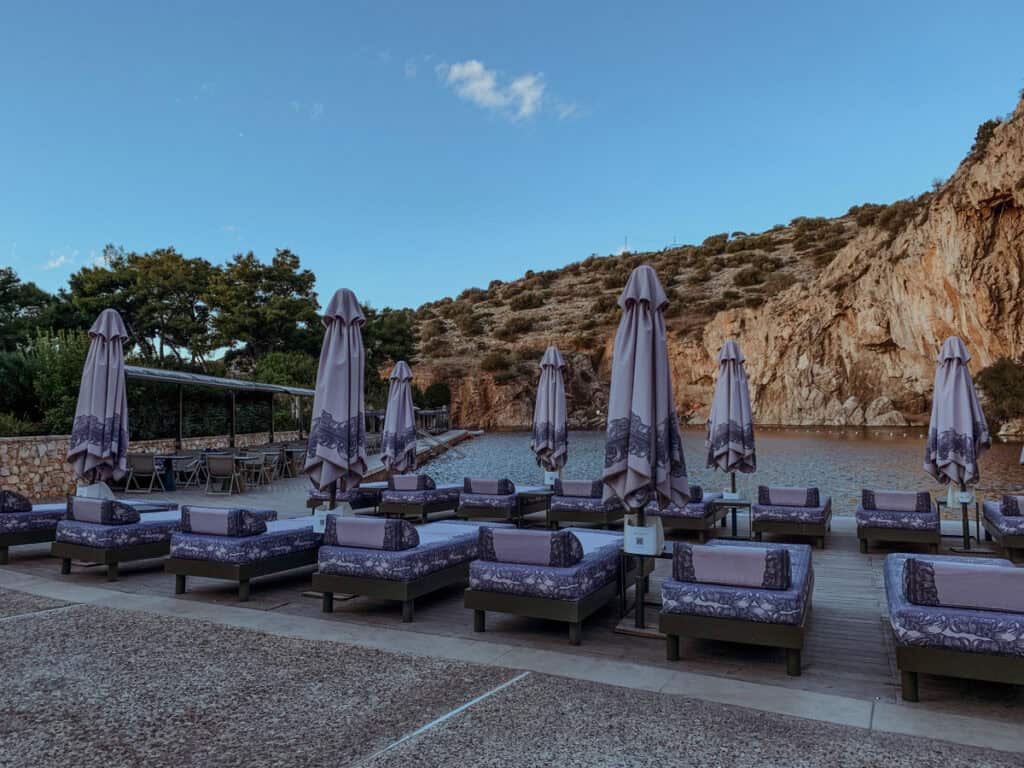 Umbrellas and sunbeds near the lake.