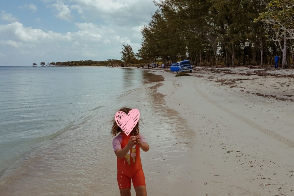 A scenic beach environment with our daughter, Norah, in the foreground.