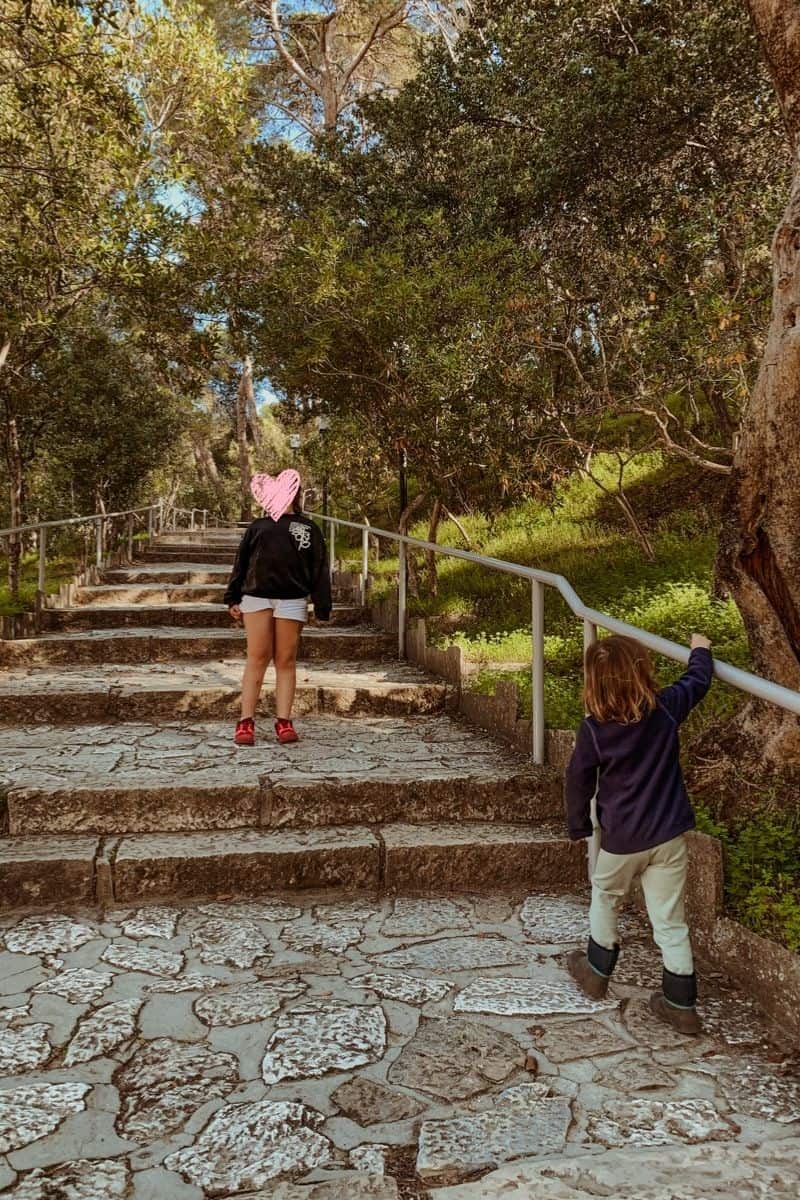 Norah and Oscar walking up the stairs during our visit to Epidaurus with kids.