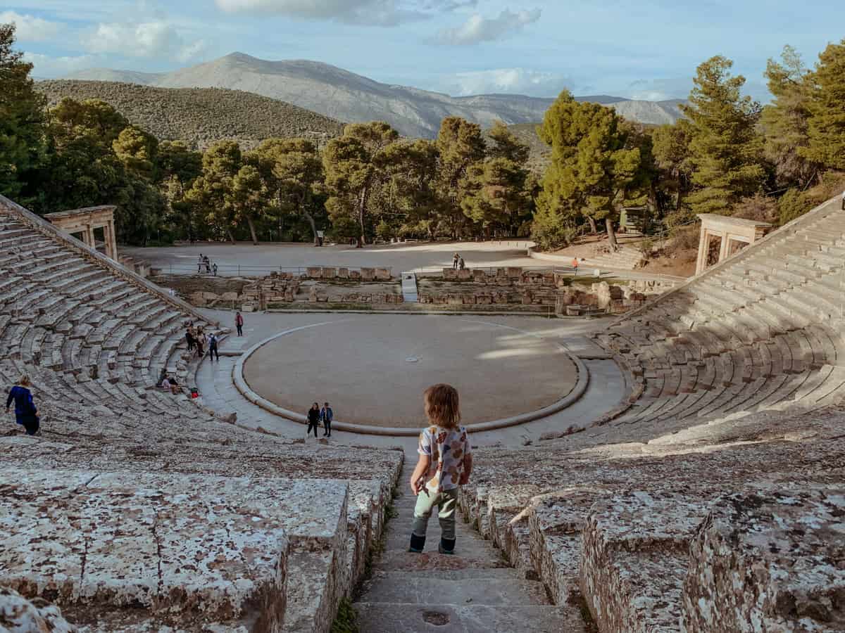 Oscar standing on the stone steps of the Ancient Theatre of Epidaurus.