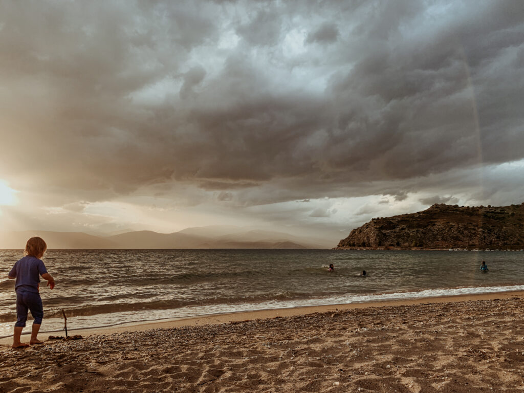 Oscar on the sand at Karathona Beach under a cloudy sky.