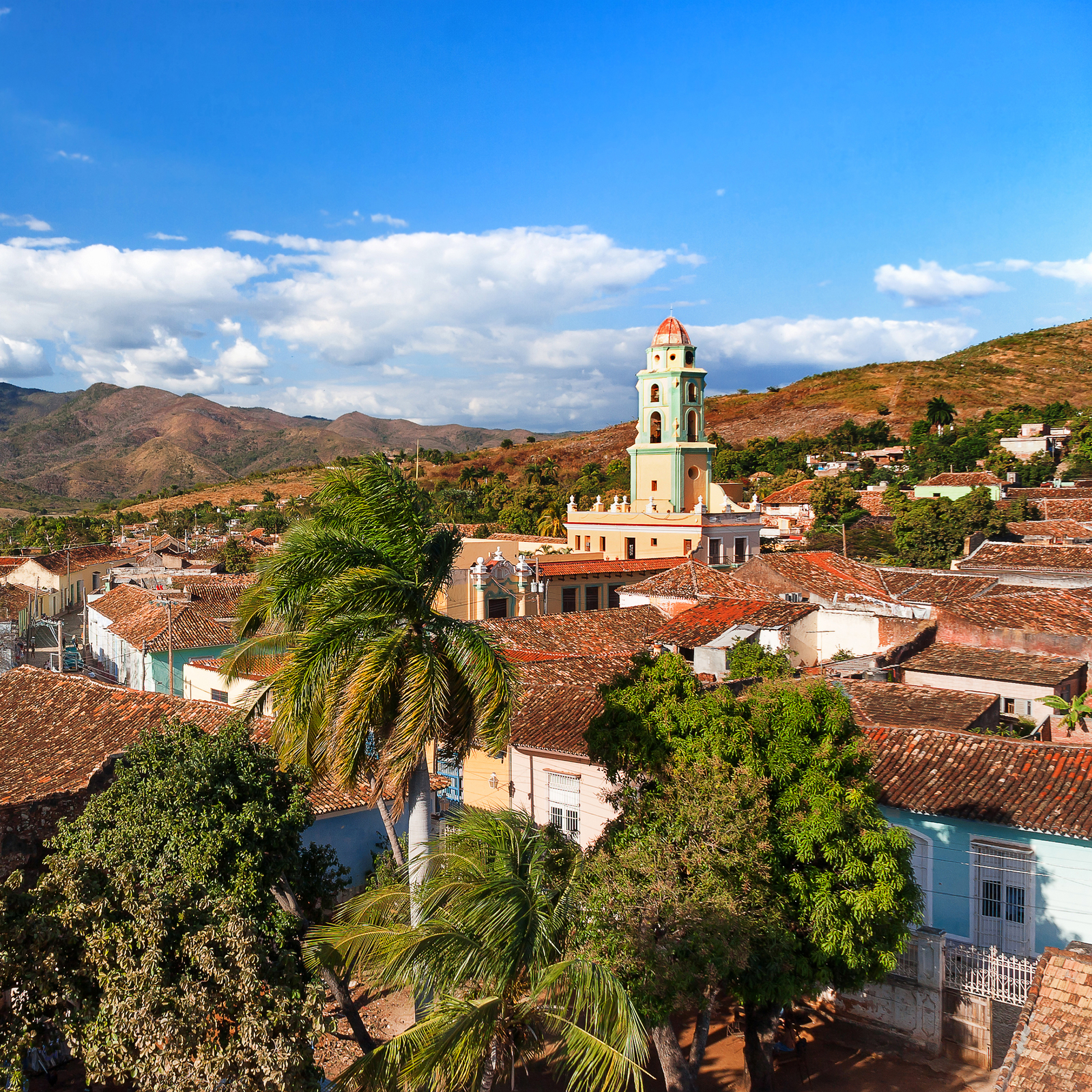 View of Trinidad’s terracotta-tiled rooftops, with the bell tower of the Convento de San Francisco de Asís, now the National Museum of the Struggle Against Bandits, visible above the town.